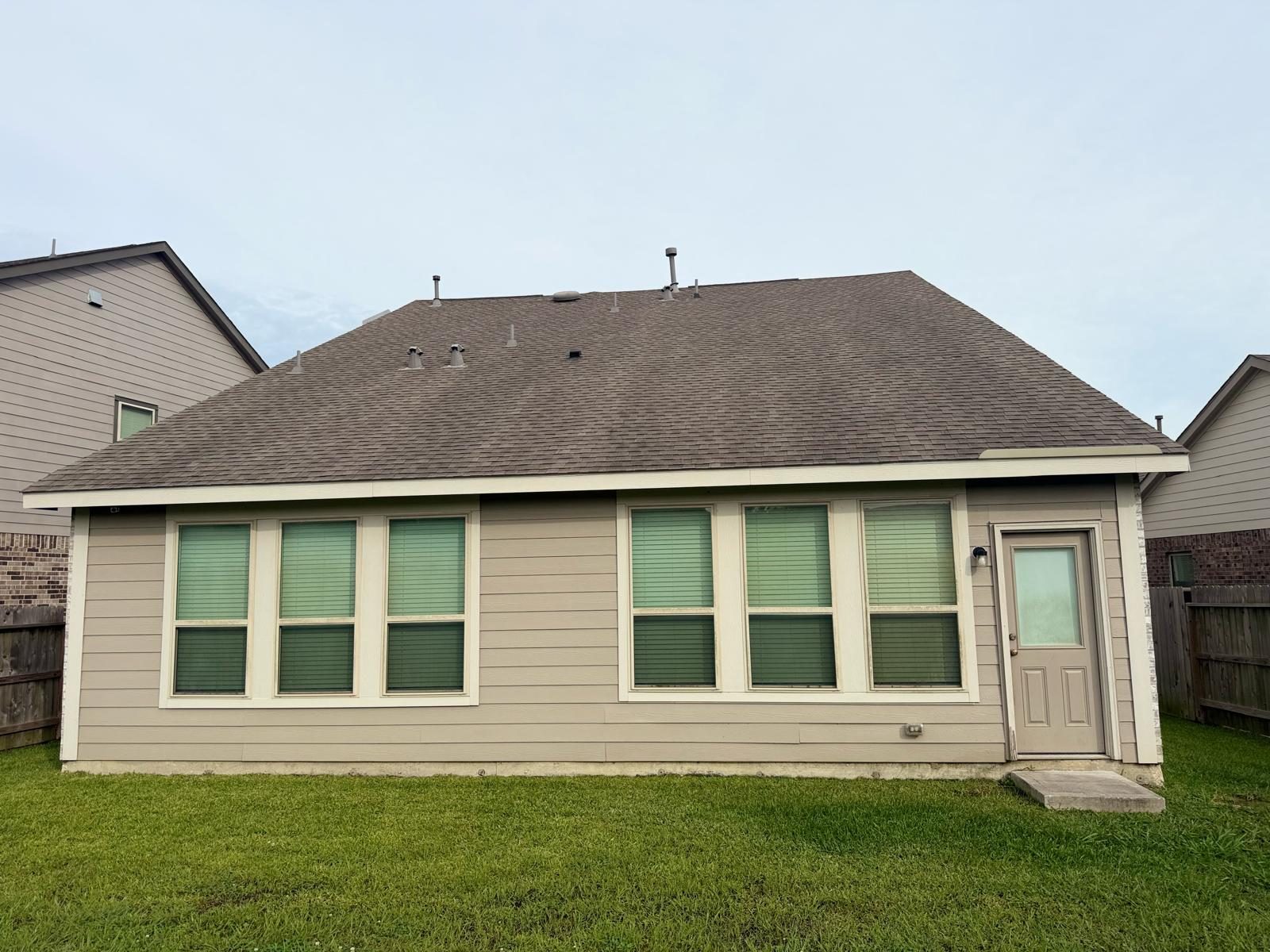 Backyard before Lira Construction LLC built a custom gable patio cover